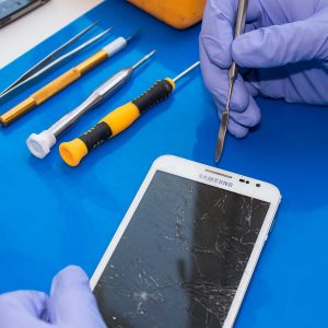 Fixing iPhone with screwdriver iphone professor staff fixing iphone in bend oregon